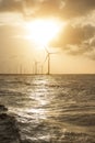 Wind turbines at sunset. Ecology wind against cloudy sky background with copy space Royalty Free Stock Photo