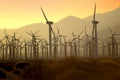 Wind turbines at sunset generating power as a fire is out of control burning nearby Palm Springs, California. Royalty Free Stock Photo