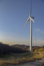 Wind turbines at sunset Production of alternative energy and conservation of the environment. Trentino, Italy Royalty Free Stock Photo