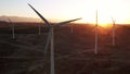 Wind Turbines at Sunset. Windenergy farm with many turbine windwill generating alternative energy. Windy park