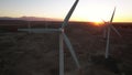 Wind Turbines at Sunset. Windenergy farm with many turbine windwill generating alternative energy. Windy park