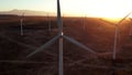 Wind Turbines at Sunset. Windenergy farm with many turbine windwill generating alternative energy. Windy park