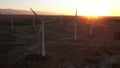 Wind Turbines at Sunset. Windenergy farm with many turbine windwill generating alternative energy. Windy park