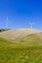 Wind turbines on the top of green hills Royalty Free Stock Photo