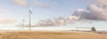 Wind turbines on a vast field panorama Royalty Free Stock Photo