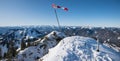 Wind vane in the bavarian alps, mountain top wallberg, snowy winter landscape panorama bavaria