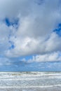 Wind and waves create foam on the beach Royalty Free Stock Photo