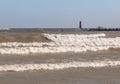 Wind Whipped Waves and Tiny Surfers Near Lighthouse