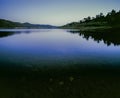 Hill and landscape reflecting in lake Windamere Dam New South Wales Australia at blue hour