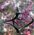 Windchime against pink camelia backdrop Royalty Free Stock Photo