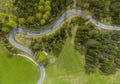 winding alpine road in the forest with green meadows and forests in the valley lechtal