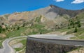 Winding asphalt road runs under the majestic Alps in scenic French countryside. Royalty Free Stock Photo