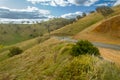 Winding Australian country road through a dry grassy hillside vista Royalty Free Stock Photo