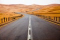 Winding black asphalt road through the sand dunes of Liwa oasis, United Arab Emirates Royalty Free Stock Photo