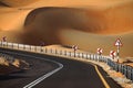 Winding black asphalt road through the sand dunes of Liwa oasis, United Arab Emirates Royalty Free Stock Photo