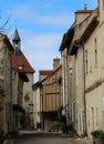 Winding cobblestone lane lined with classic brick buildings in Charroux, France