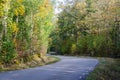 Winding country road in fall season Royalty Free Stock Photo