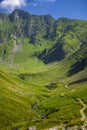 Winding country road in a mountain valley. The Fagaras Mountains, Carpathians, Romania Royalty Free Stock Photo