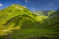 Winding country road in a mountain valley. The Fagaras Mountains, Carpathians, Romania Royalty Free Stock Photo