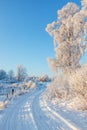 Winding country road in a snowy winter landscape Royalty Free Stock Photo