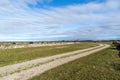 Winding country road in a wide open plain grassland Royalty Free Stock Photo