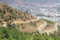 Winding or curved asphalt road on the hill with view of Thimphu Royalty Free Stock Photo