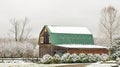 Green roof rustic barn in Winter snow and blue sky Royalty Free Stock Photo