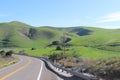 Winding curved road bright mountain hillside blue sky Royalty Free Stock Photo