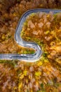 Winding curved road with cars and trucks on the road. Aerial vie