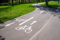 Winding cycleway with pictograms and directional guidance in summer park Royalty Free Stock Photo