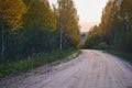 Winding dirt road through the autumn forest. Beautiful autumn landscape Royalty Free Stock Photo