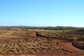 Winding dirt road with empty landscape in outback Australia Royalty Free Stock Photo