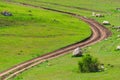 Winding dirt road among green field Royalty Free Stock Photo