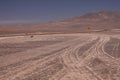 Winding endless dirt road to the nowhere of Pan de Azucar at pacific coast,  yellow sign showing left direction Royalty Free Stock Photo