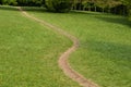 Winding footpath on a sunny meadow Royalty Free Stock Photo