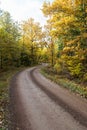 Winding gravel road in fall season colors Royalty Free Stock Photo