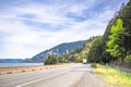 Winding highway road along the Columbia River with big rig semi truck and dry van semi trailer and another traffic in Columbia Royalty Free Stock Photo