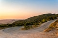 Winding mountain road curve on Corfu island in Greece at sunset. Beautiful landscape view of hills and mountains with Royalty Free Stock Photo