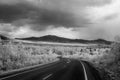 A winding mountain road descends. IR photo