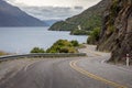 Winding mountain road lies in the foreground of a breathtaking landscape in Queenstown, New Zealand Royalty Free Stock Photo