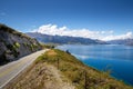 Winding mountain road lies in the foreground of a breathtaking landscape in Queenstown, New Zealand Royalty Free Stock Photo