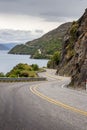 Winding mountain road lies in the foreground of a breathtaking landscape in Queenstown, New Zealand Royalty Free Stock Photo