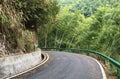 The winding mountain road meanders through the mountains and dense bamboo forests