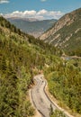 Winding Mountain Road with Motorcyclist in Distance Royalty Free Stock Photo