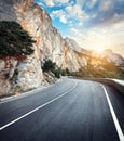 Winding mountain road with rocks, blue sky at sunset Royalty Free Stock Photo