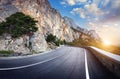 Winding mountain road with rocks, blue sky at sunset Royalty Free Stock Photo