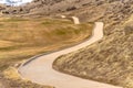 Winding narrow rural road through foothills golf