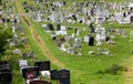 LLandudno, Wales, North Shore Beach, UK - MAY 27, 2018 winding path old cemetery. Graveyard with crosses tinny road middle of it.