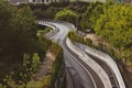 Winding paved empty road goes into distance among trees aerial view. A highway. Royalty Free Stock Photo