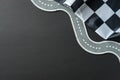 Winding puzzle road with dashed lines and checkered flag on dark background Royalty Free Stock Photo